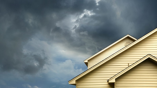 storm looming over house home insurance